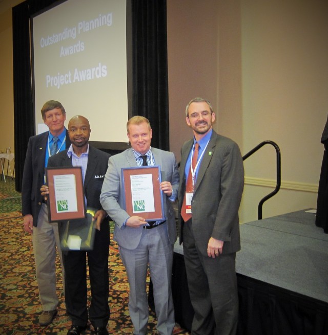 Photos Courtesy of Dylan McKnight. Dylan McKnight, second from right, and Rickey Hall, third from right, receive an award from the N.C. Chapter of the American Planning Association President John Morck, left, and exiting president Bejamin Hitchings for their work on the Reid Neighborhood Park.