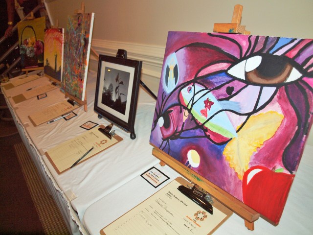 At the Mosaic Awards, there was food, entertainment and a silent auction of Behailu’s students’ artwork. The painting on the right is titled Different Perspectives.